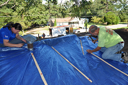 Sallie Clamp & Rev. Bob Allen of SC ERT tarp the roof of a damaged home in Holly Hill, SC