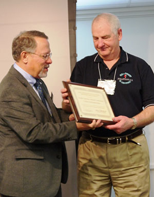 Gil (left) presents award to Herman Lightsey
